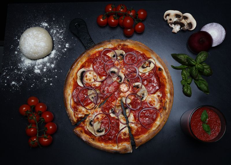 Variety of marcos pizza toppings laid out fresh